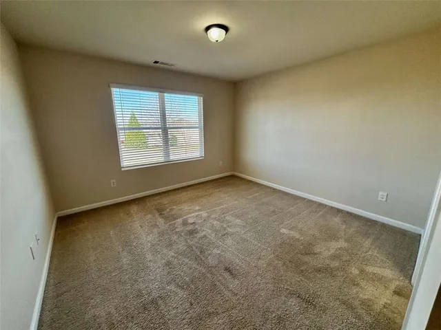 a view of an empty room and a window