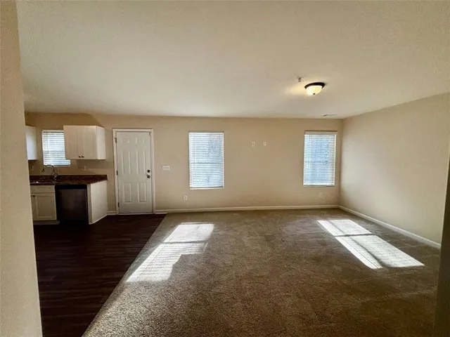 a bathroom with a granite countertop sink toilet and a mirror