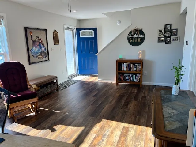 a view of a workspace with furniture and wooden floor
