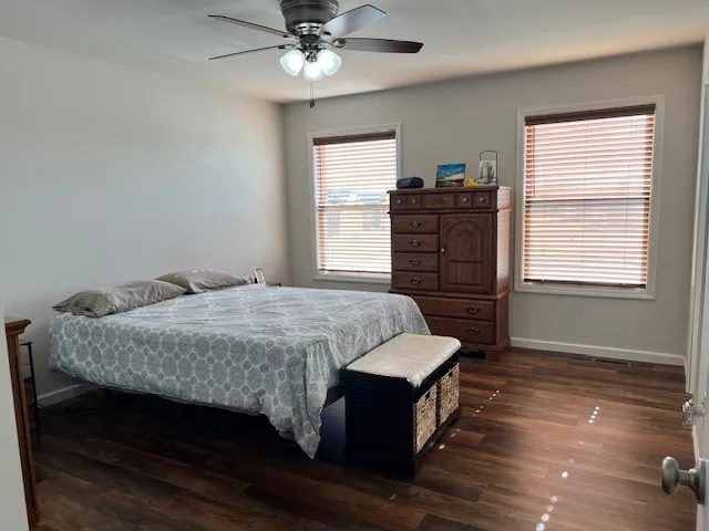 a bedroom with a bed dresser and a window
