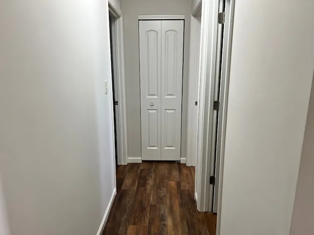 a view of a hallway with wooden floor