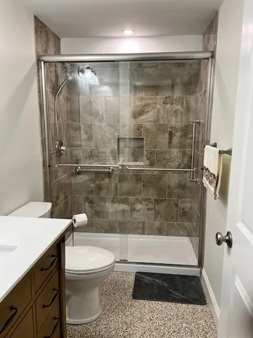 a bathroom with a shower a toilet and a sink