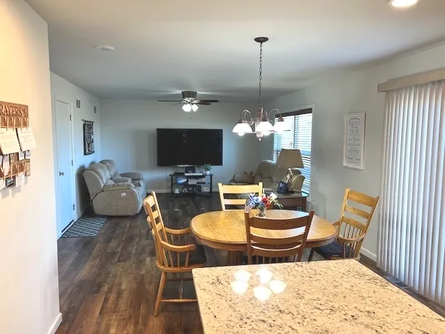 a living room with furniture a chandelier and a flat screen tv