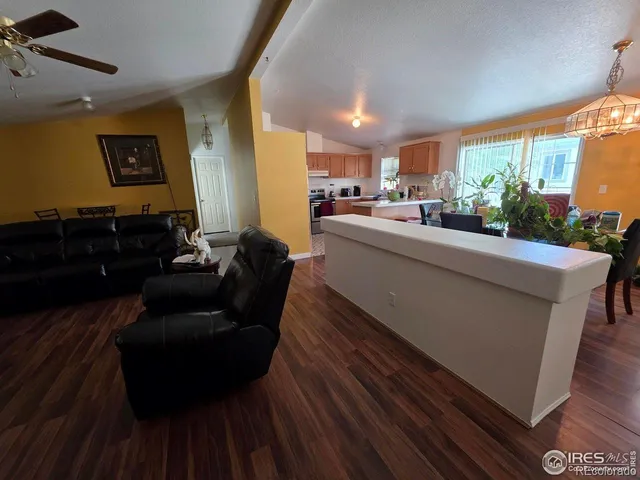 a kitchen with a sink a stove and chairs