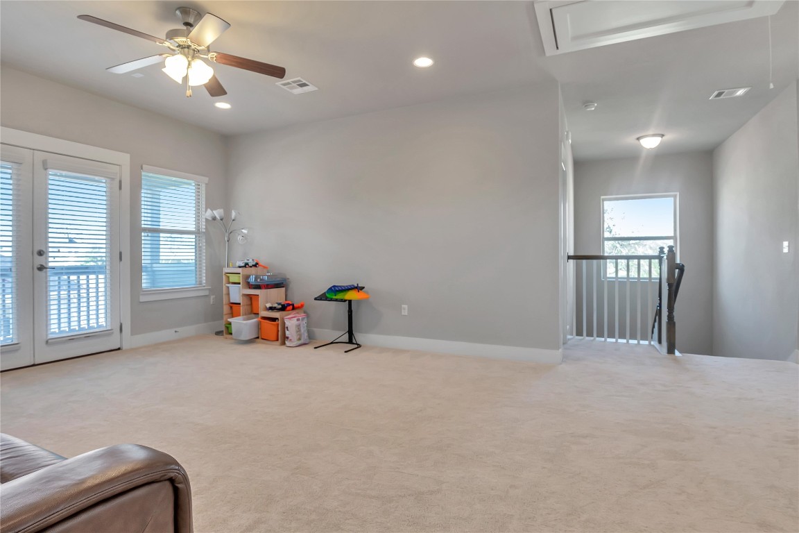 9302 McKnight Loop, Unit 43 Austin, TX 78717 - Photo 12 of 24 a view of an empty room with window and chandelier fan