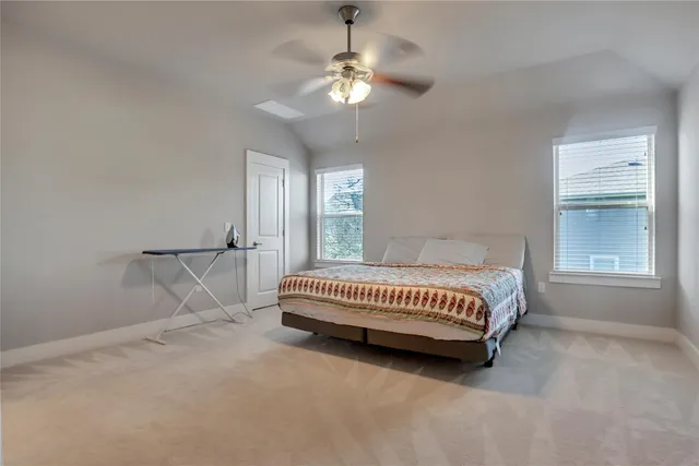 a spacious bedroom with a bed and a window