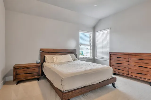 a bedroom with a bed and a dresser next to it