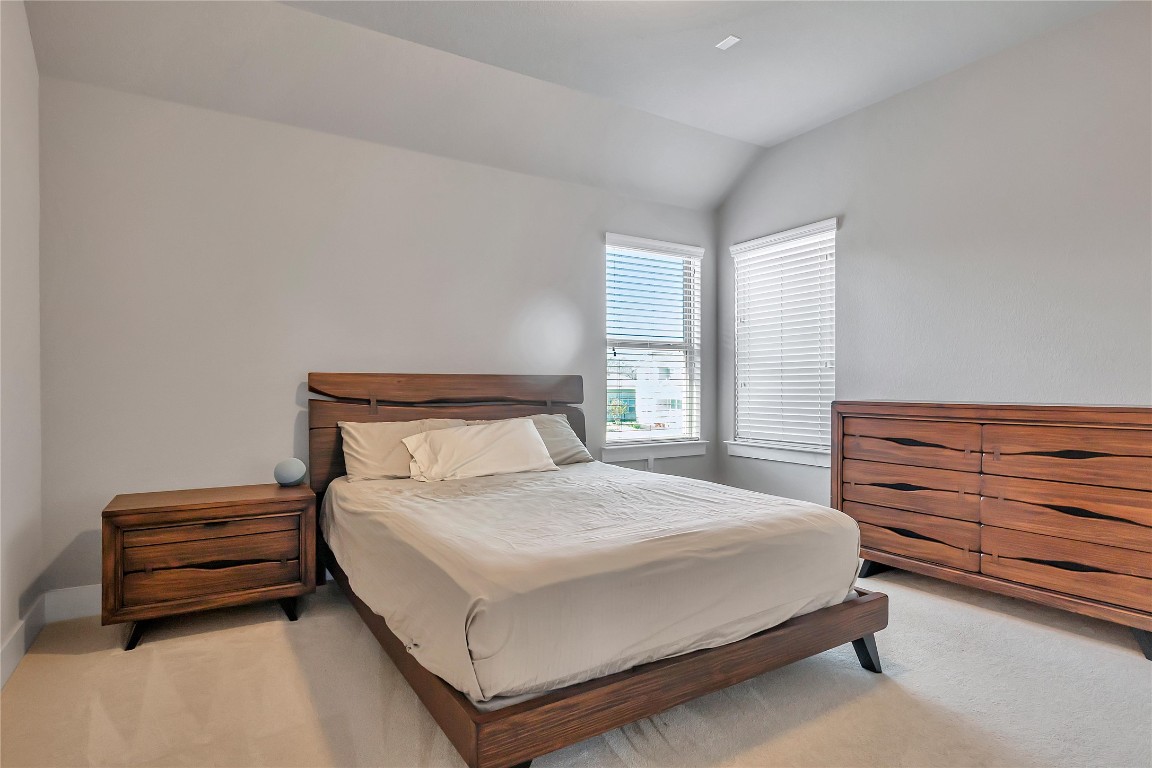 9302 McKnight Loop, Unit 43 Austin, TX 78717 - Photo 18 of 24 a bedroom with a bed and a dresser next to it