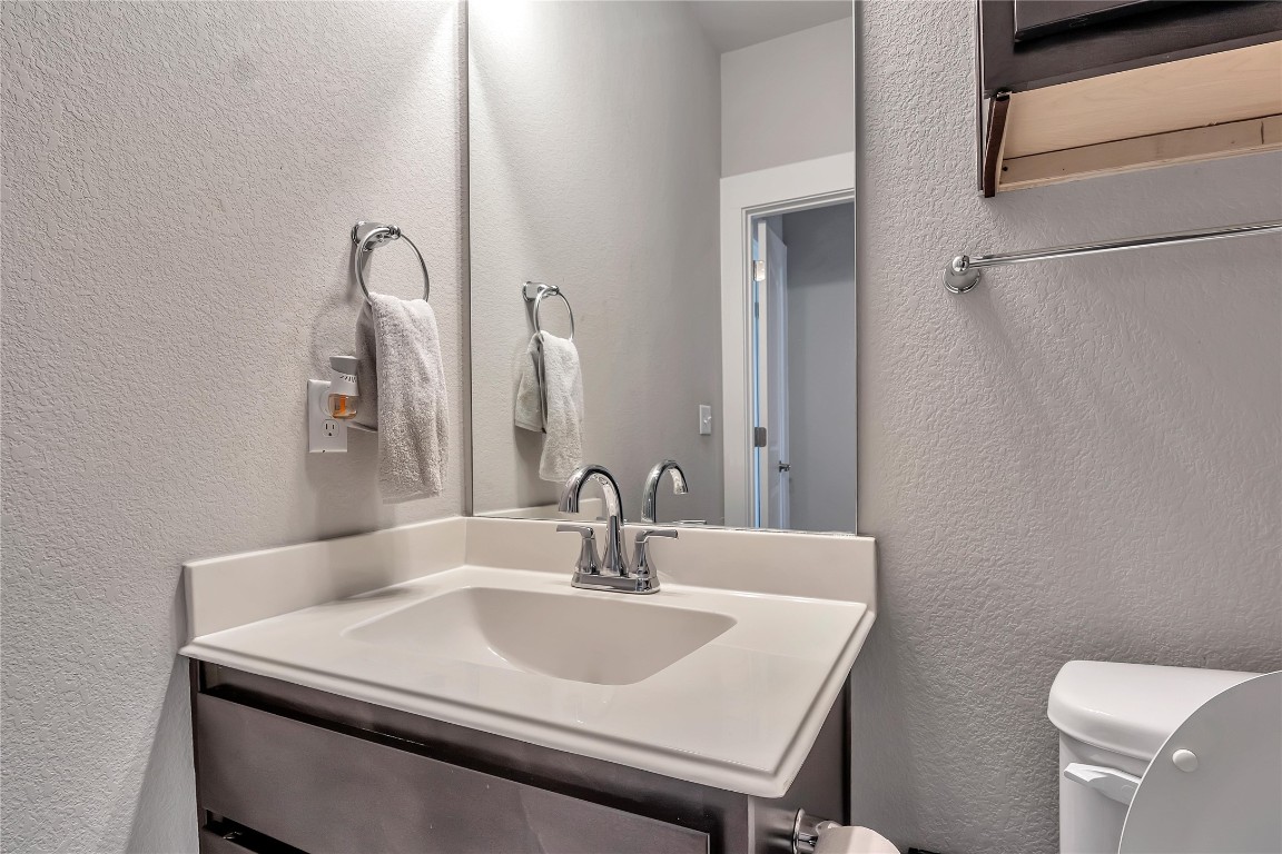 9302 McKnight Loop, Unit 43 Austin, TX 78717 - Photo 19 of 24 a bathroom with a sink and a mirror