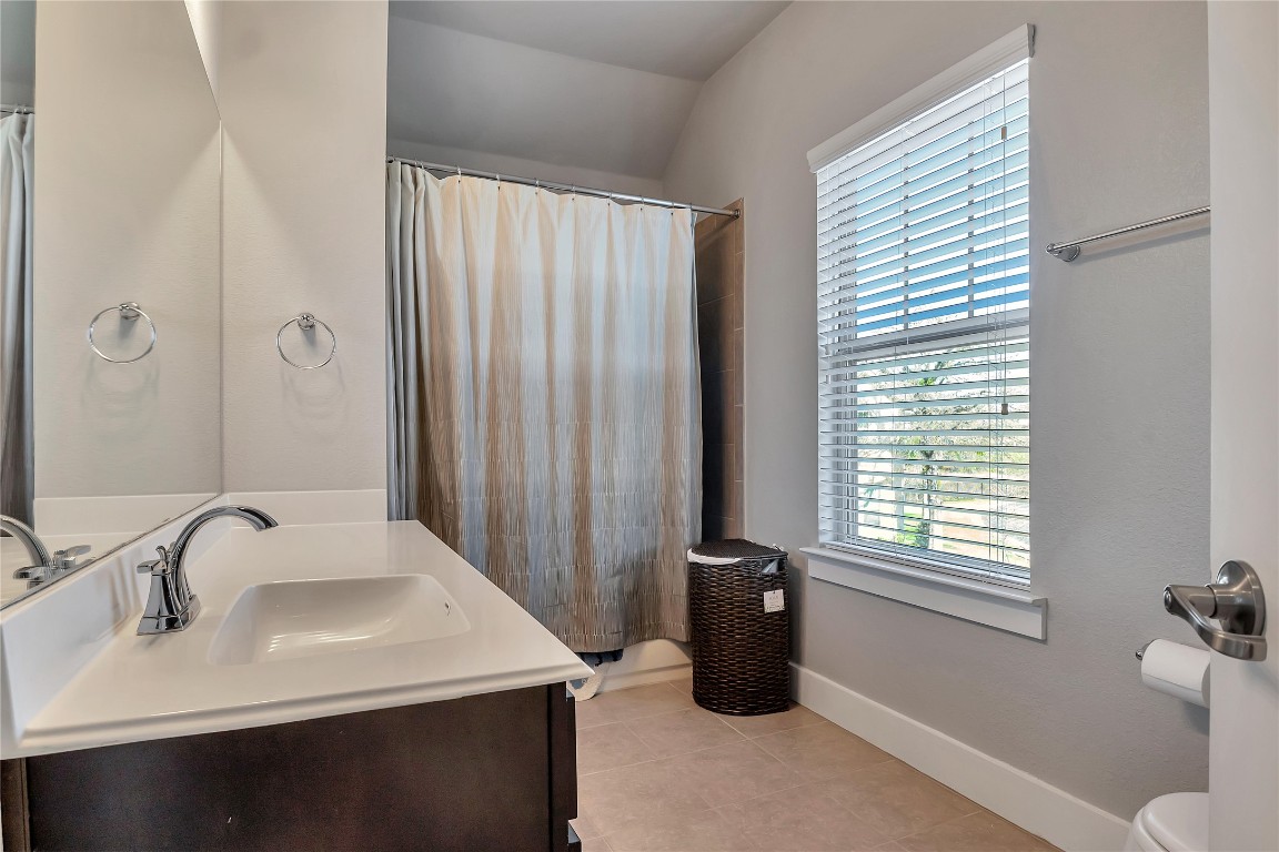 9302 McKnight Loop, Unit 43 Austin, TX 78717 - Photo 22 of 24 a bathroom with a sink and a mirror