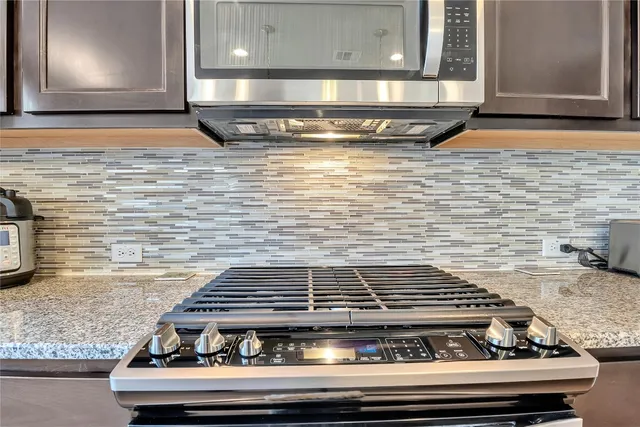 a stove top oven sitting inside of a kitchen