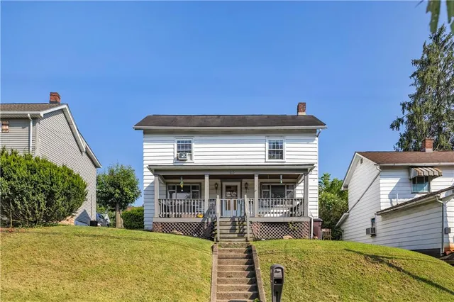 a view of house with outdoor space and swimming pool