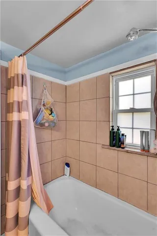 a bathroom with a bathtub and a shower