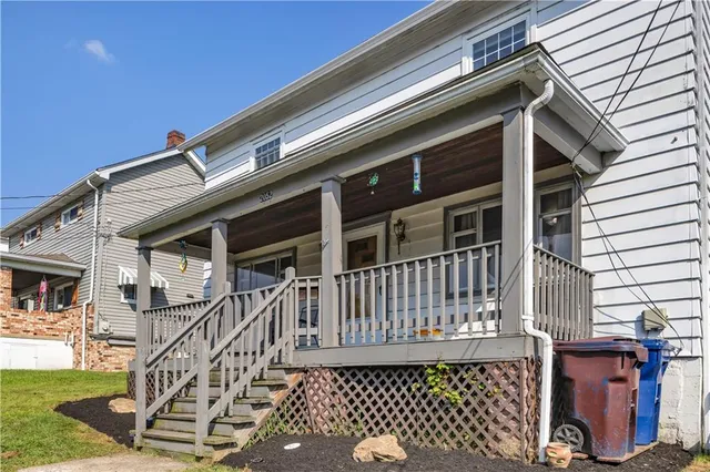 a view of a house with wooden deck