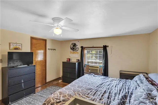 a bedroom with a bed and a dresser in it