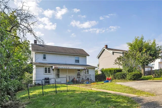 a view of a house with a yard porch and sitting area