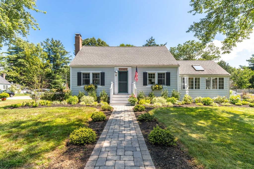 a front view of house with yard and green space