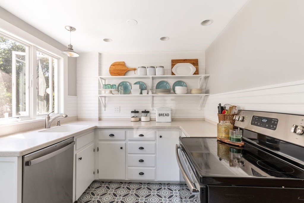2 Ross Road Topsfield, MA 01983 - Photo 14 of 36 a kitchen with stainless steel appliances a sink a stove and a window