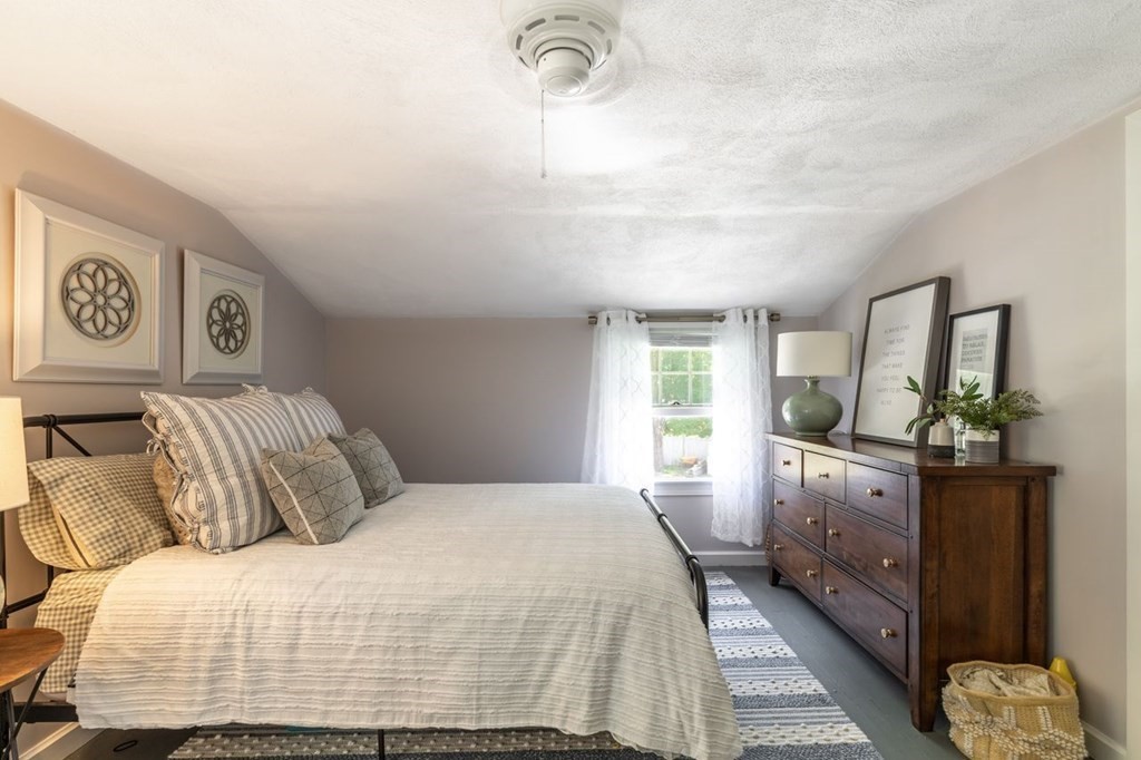2 Ross Road Topsfield, MA 01983 - Photo 21 of 36 a bedroom with a large bed and a chandelier