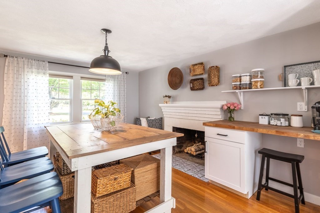 2 Ross Road Topsfield, MA 01983 - Photo 10 of 36 a kitchen with a stove a sink a dining table and chairs with wooden floor