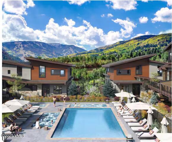 42 Riverfront Lane, Unit 205 Avon, CO 81620 - Photo 13 of 20 a front view of a house with swimming pool and sitting area