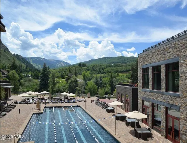 a view of a terrace with furniture and a garden
