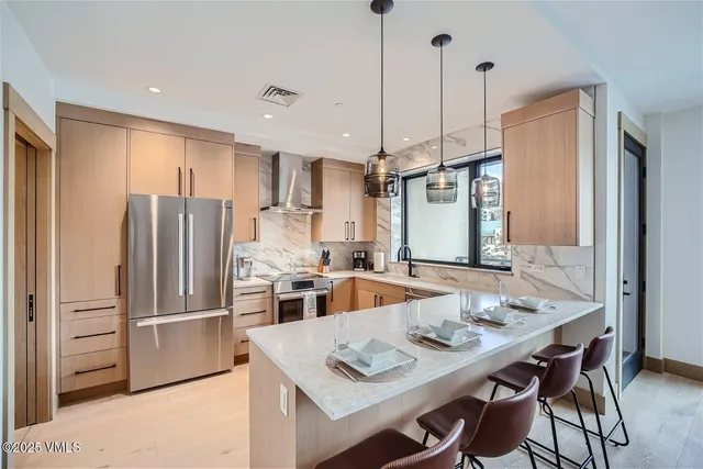 a kitchen with refrigerator cabinets and wooden floor