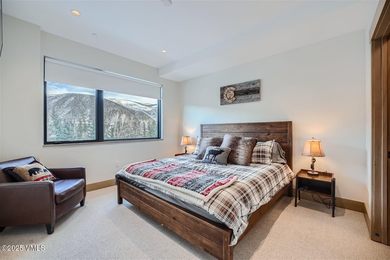 42 Riverfront Lane, Unit 205 Avon, CO 81620 - Photo 4 of 20 a bedroom with a bed and a couch