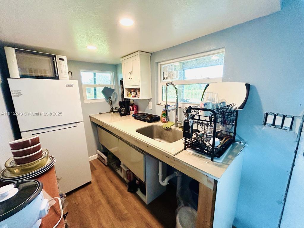 6588 4th Road LaBelle, FL 33935 - Photo 12 of 16 a kitchen with a sink appliances and cabinets