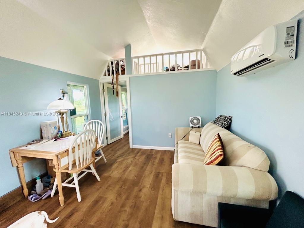 6588 4th Road LaBelle, FL 33935 - Photo 5 of 16 a living room with furniture and a wooden floor