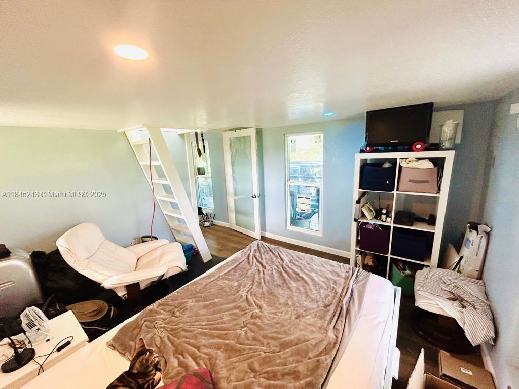 6588 4th Road LaBelle, FL 33935 - Photo 8 of 16 a bed room with two bed and a television