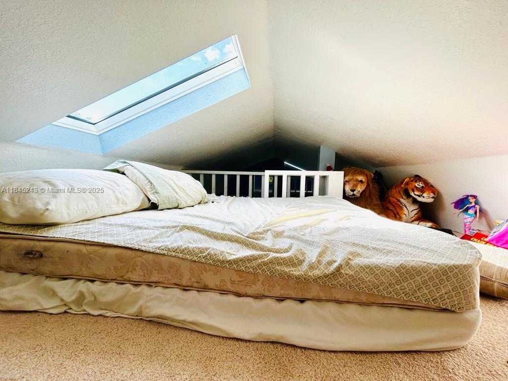 6588 4th Road LaBelle, FL 33935 - Photo 10 of 16 a large bed sitting in a bedroom next to a window