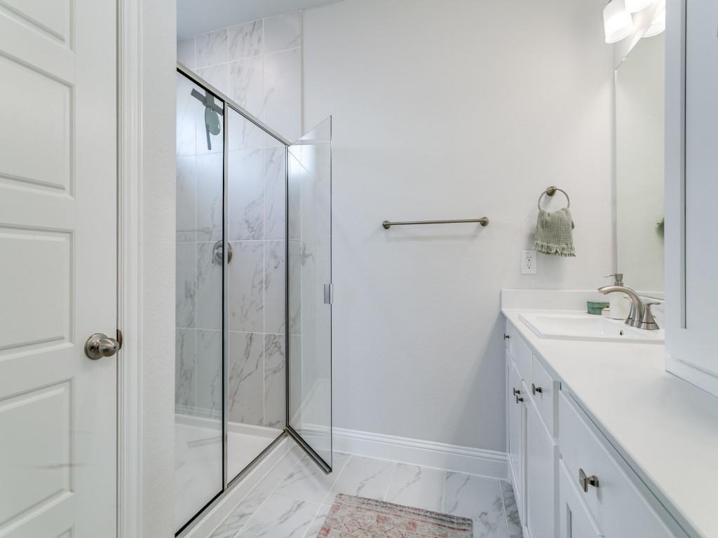 12964 Rockham Lane Dallas, TX 75234 - Photo 15 of 24 a bathroom with a double vanity sink and mirror