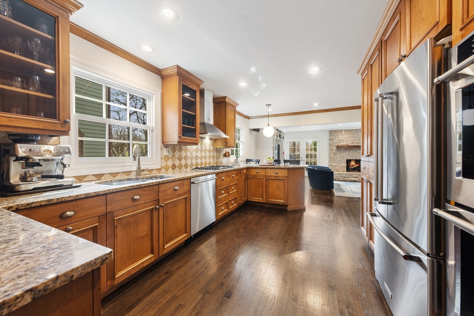 216 Bonnie Brae Hinsdale, IL 60521 - Photo 6 of 32 a kitchen with stainless steel appliances granite countertop a refrigerator a sink dishwasher a stove and white countertops with wooden floor