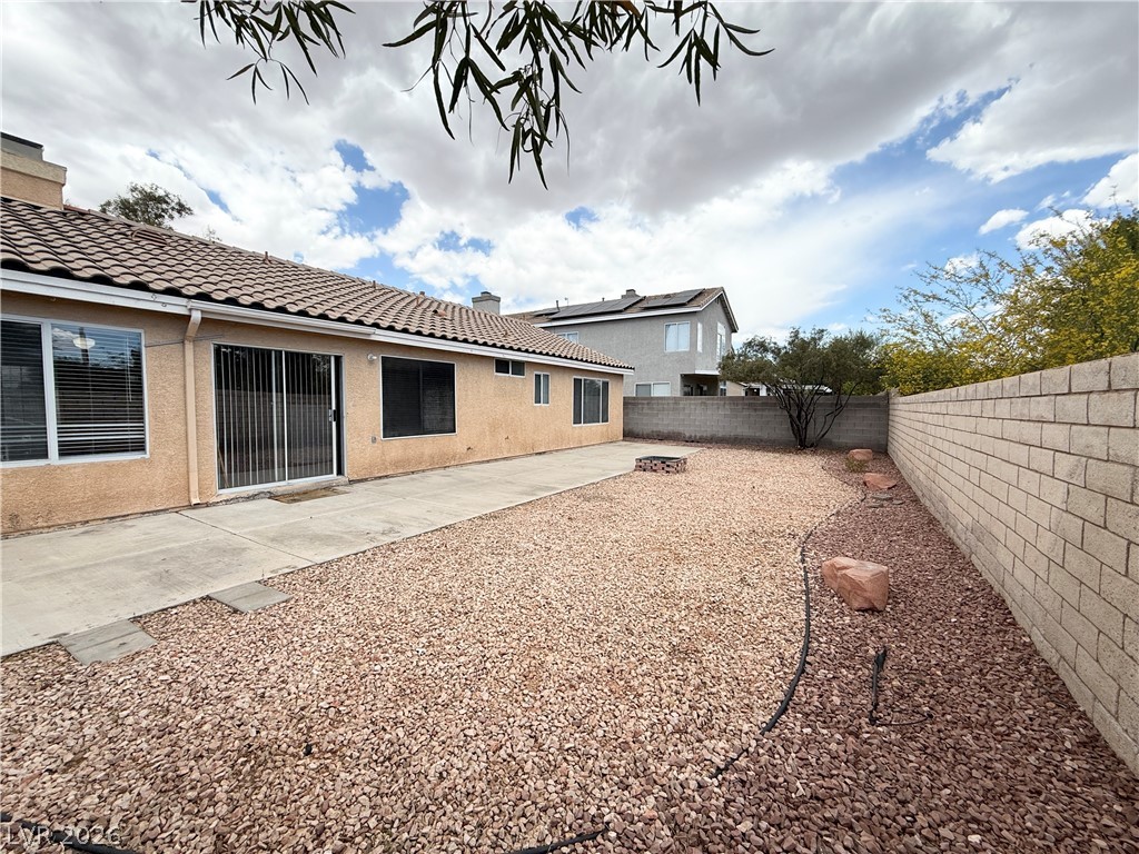 8870 Haviland Road Las Vegas, NV 89123 - Photo 22 of 24 A low-maintenance backyard oasis featuring a concrete patio and a gravel landscape, perfect for outdoor living.