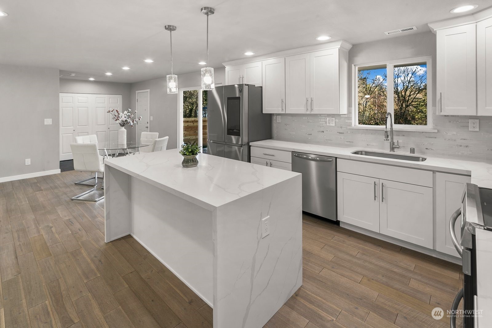 10809 Rustic Road South Seattle, WA 98178 - Photo 14 of 30 a kitchen with a sink cabinets and wooden floor