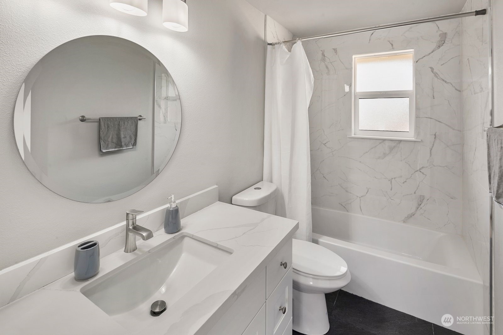 10809 Rustic Road South Seattle, WA 98178 - Photo 20 of 30 a bathroom with a sink a toilet and a mirror