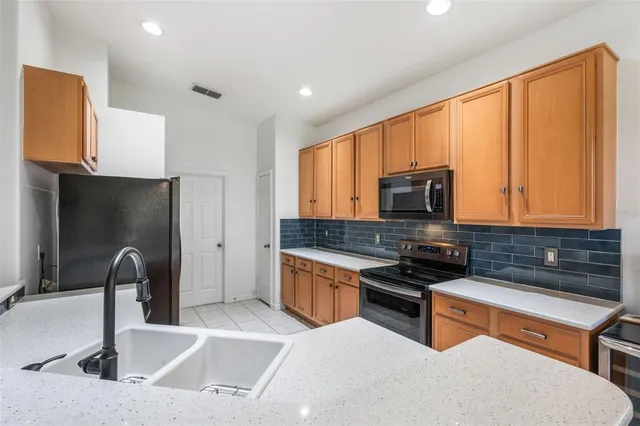a kitchen with stainless steel appliances a refrigerator sink and cabinets