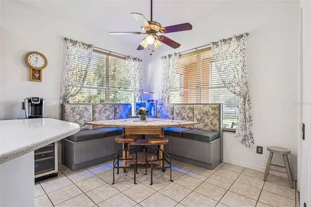a living room with stainless steel appliances kitchen island granite countertop furniture and a large window
