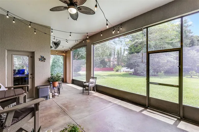 a dining room with furniture a flat screen tv and a potted plant