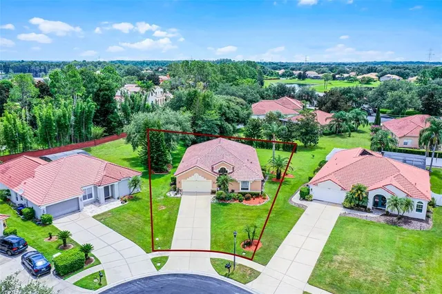 an aerial view of a house with garden space and street view