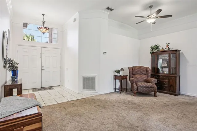 a living room with furniture ceiling fan and a rug