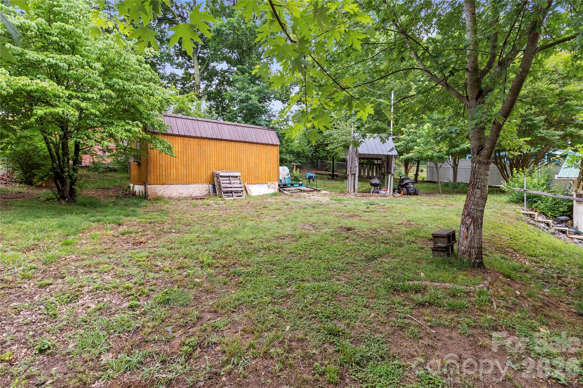 325 Swanson Road Lenoir, NC 28645 - Photo 34 of 35 a backyard of a house with table and chairs