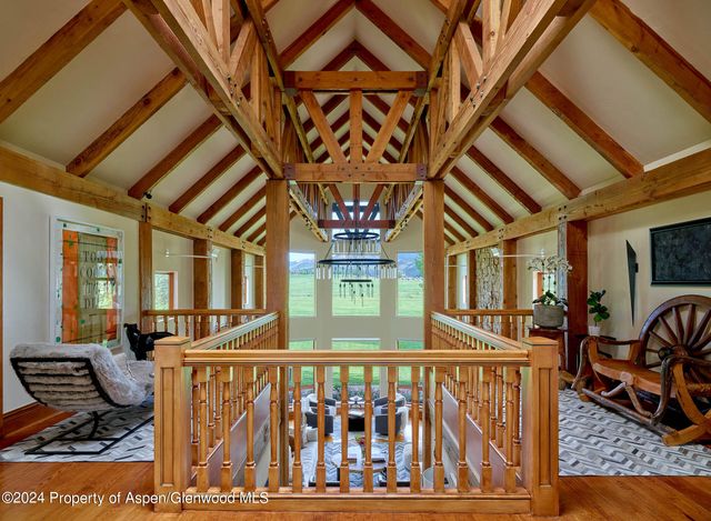 a kitchen with a sink and large windows
