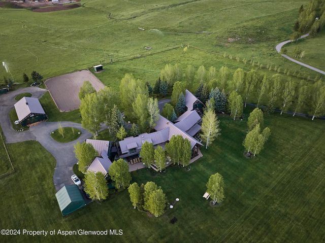 a living room with fireplace furniture and a large window