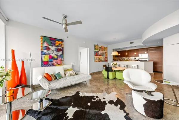 a living room with furniture fireplace and white walls