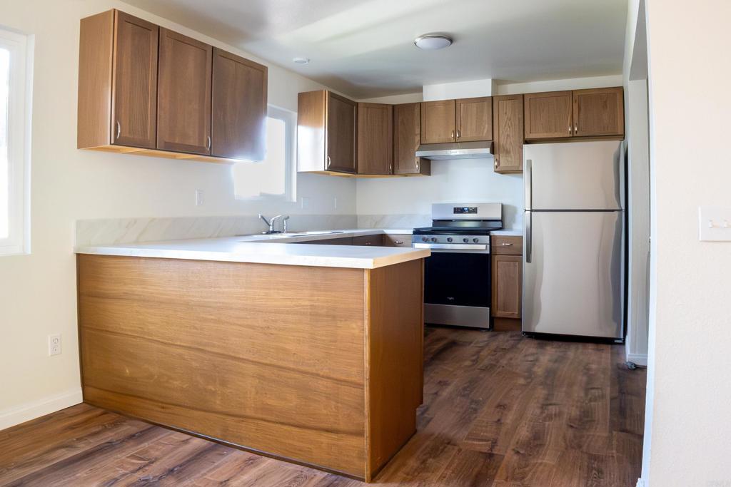a kitchen with a sink a stove and refrigerator