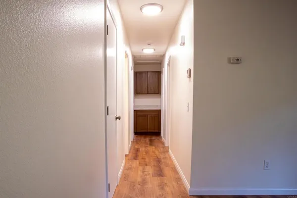 a view of a hallway with wooden floor