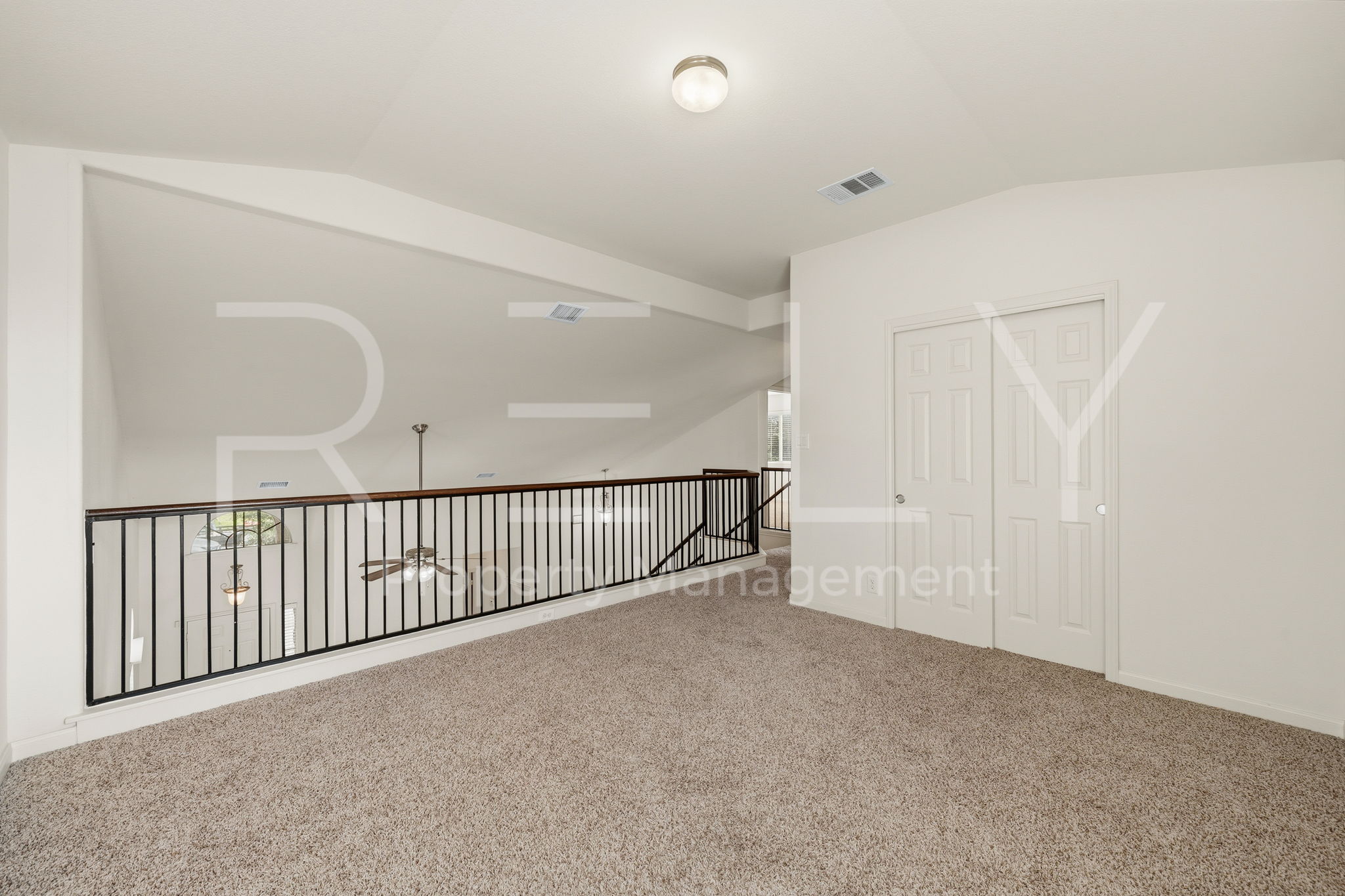 1405 Sunny Meadows Loop Georgetown, TX 78626 - Photo 24 of 40 An open loft space with plush carpeting offers versatile living options, overlooking the lower level.