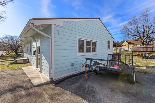 a view of a house with wooden fence